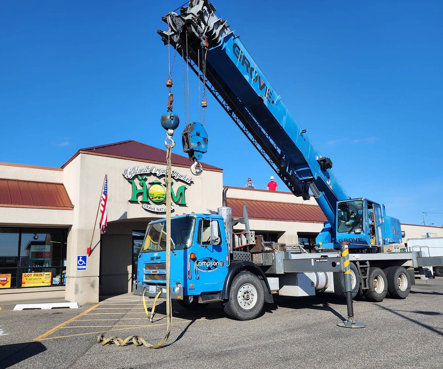 Crane setting a rooftop unit on a Tri-Cities storefront